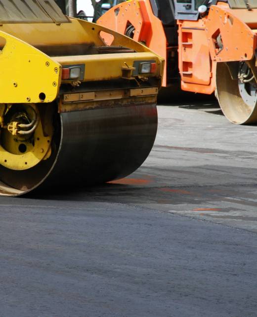 Two asphalt rollers working in the street, no people, selective focus